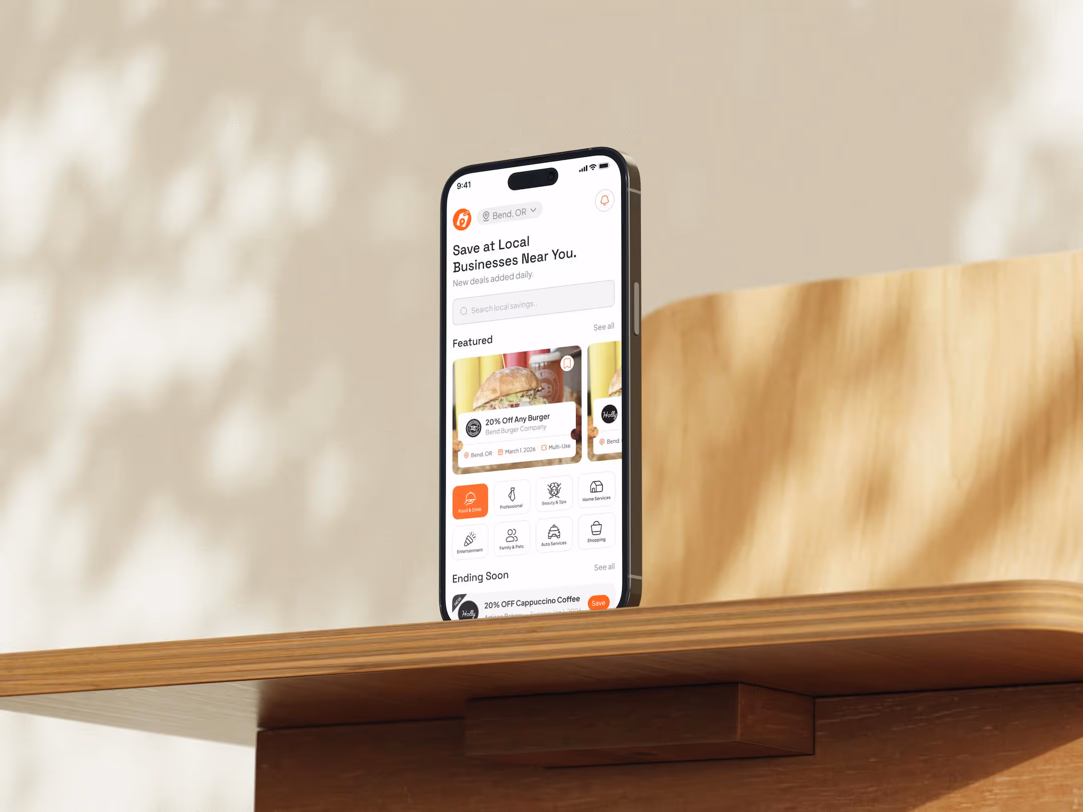 Local Coupons app displayed on an iPhone showing nearby deals and offers
